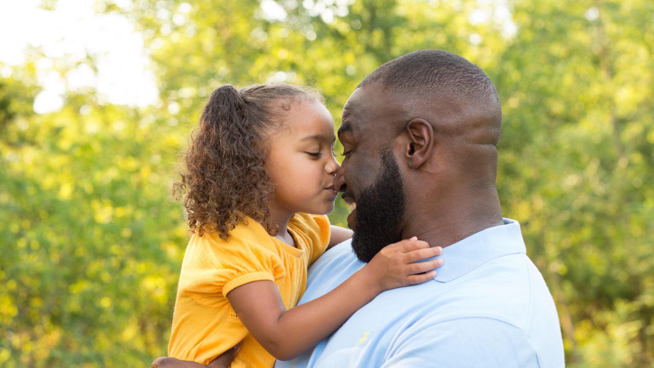 Little,Girl,Kissing,Her,Father,On,His,Nose.
